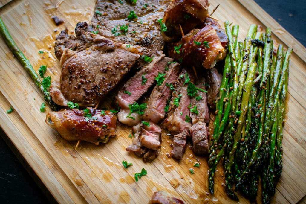 grilled meat on brown wooden chopping board